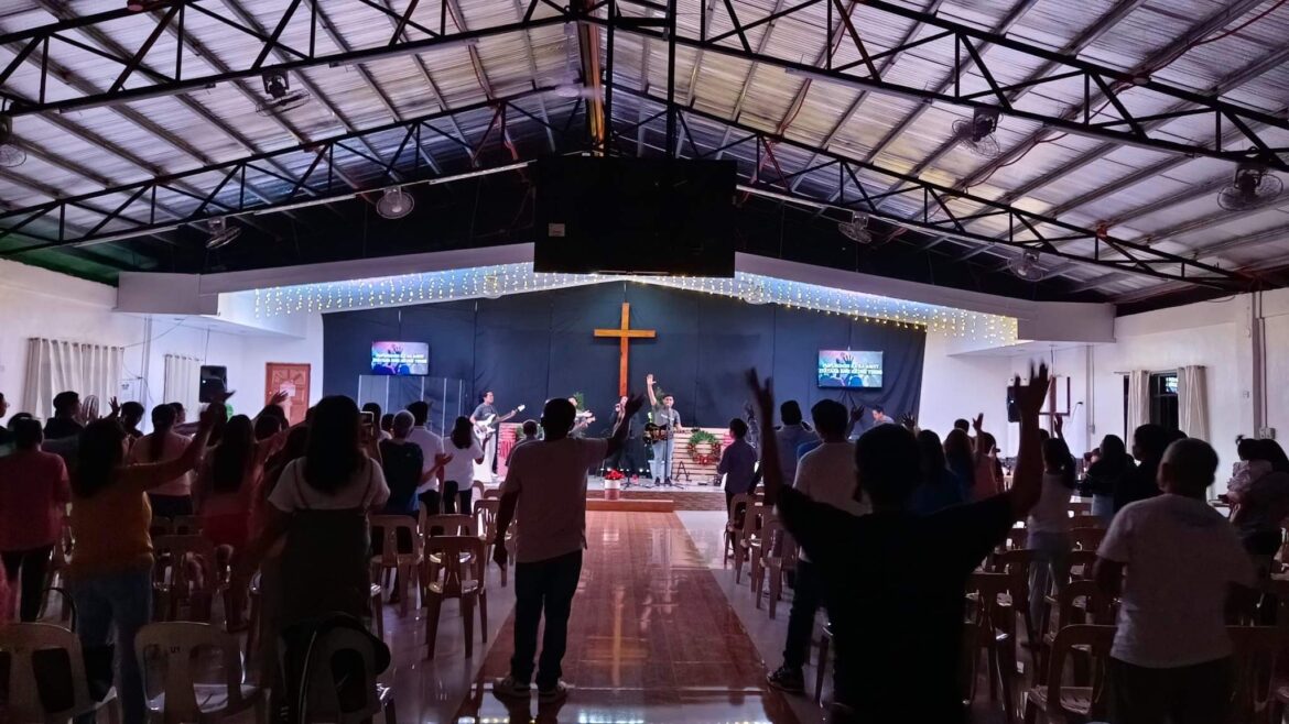 Cathedral of Faith Church with people praising and worshipping the Lord raising their hands as a sign of praise and worship